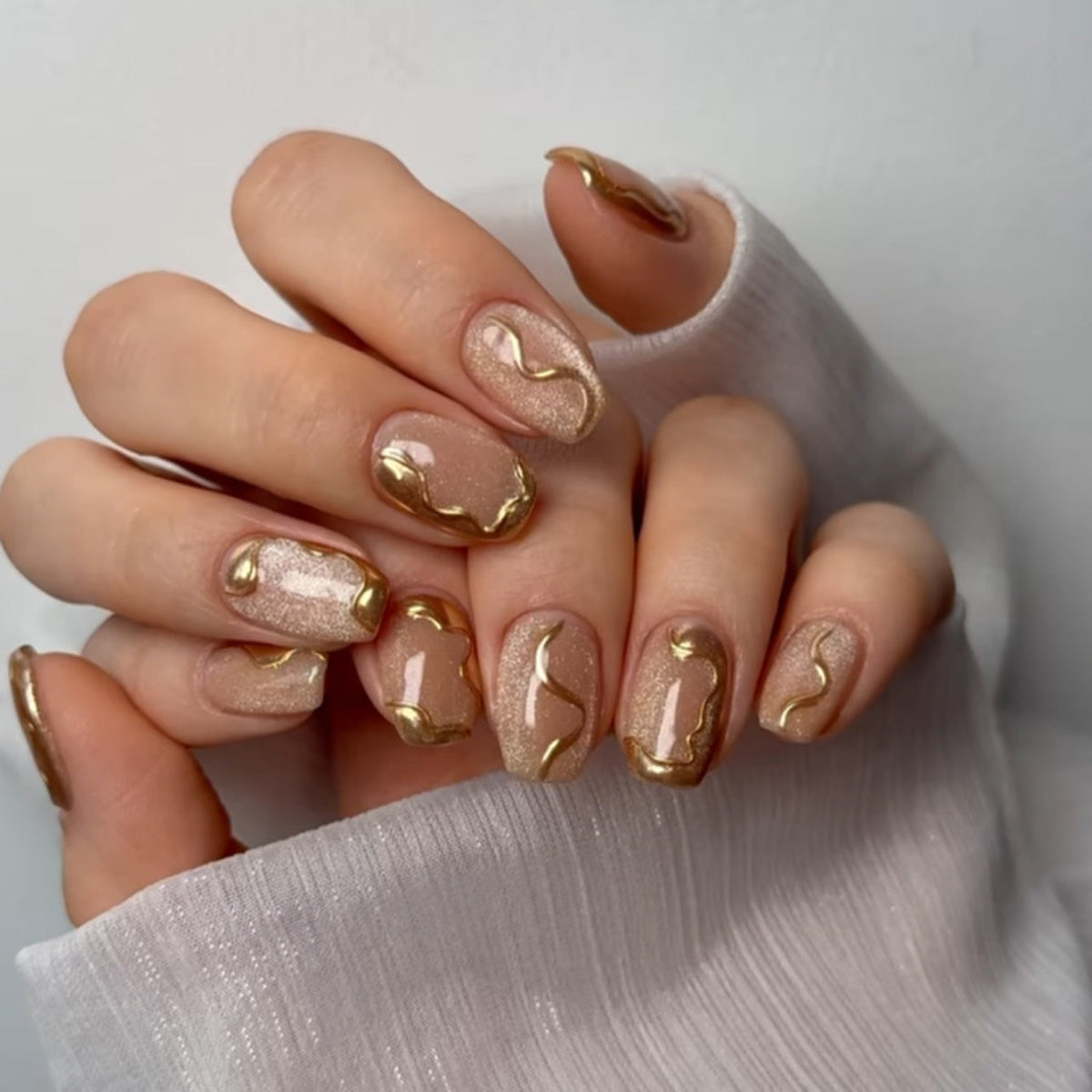 Golden Swirl Nude Nails with Shimmer Gloss Finish