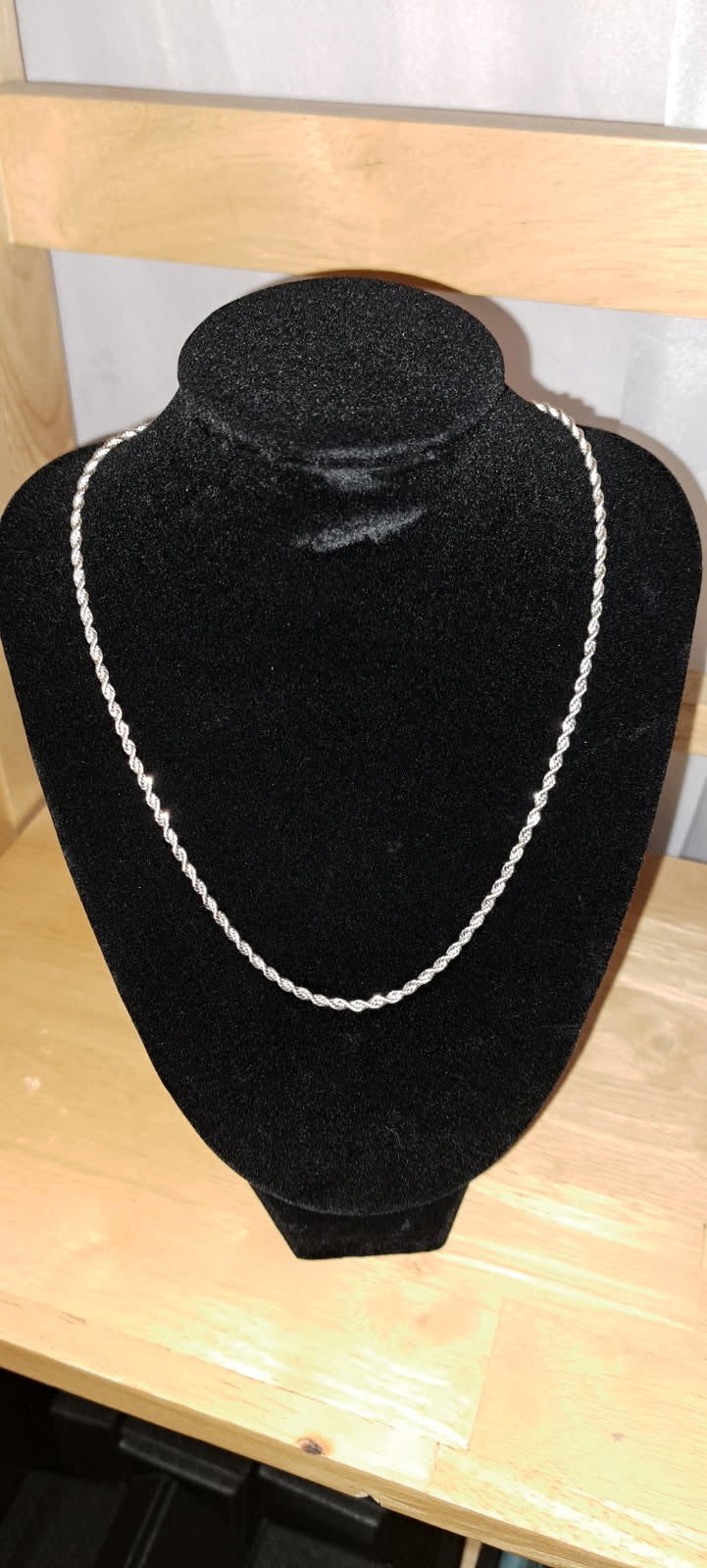 Sterling silver rope chain necklace is 16 inches long. It is made of 925 silver and has a twisted rope design.