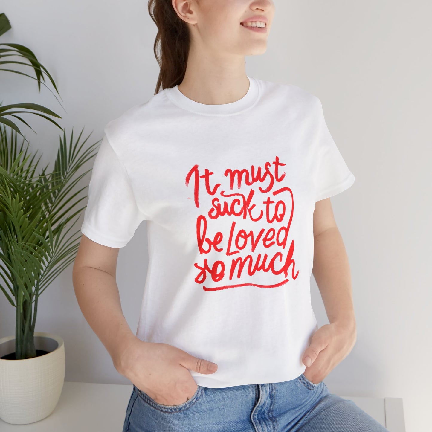 T‑Shirt — “It Must Suck to Be Loved So Much” Red Script Tee