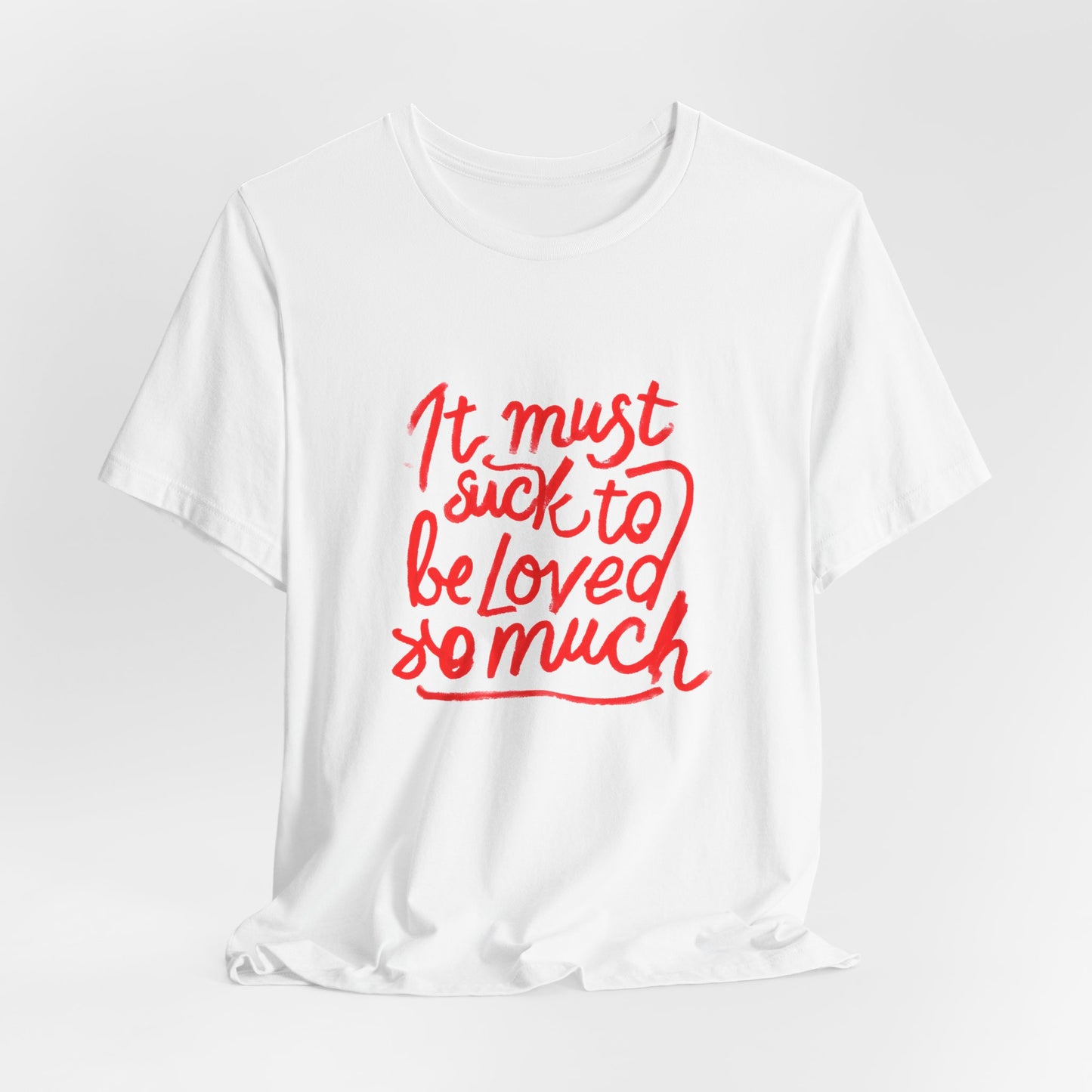 T‑Shirt — “It Must Suck to Be Loved So Much” Red Script Tee