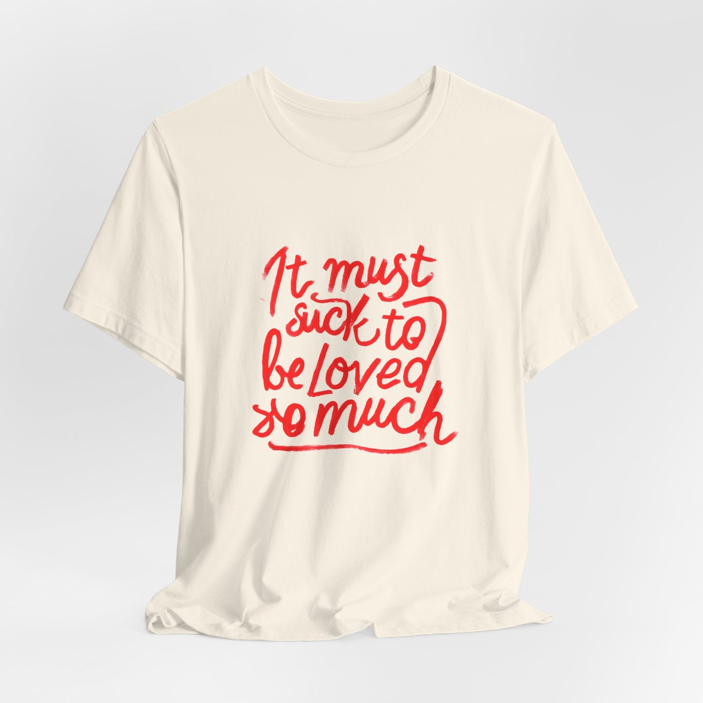 T‑Shirt — “It Must Suck to Be Loved So Much” Red Script Tee