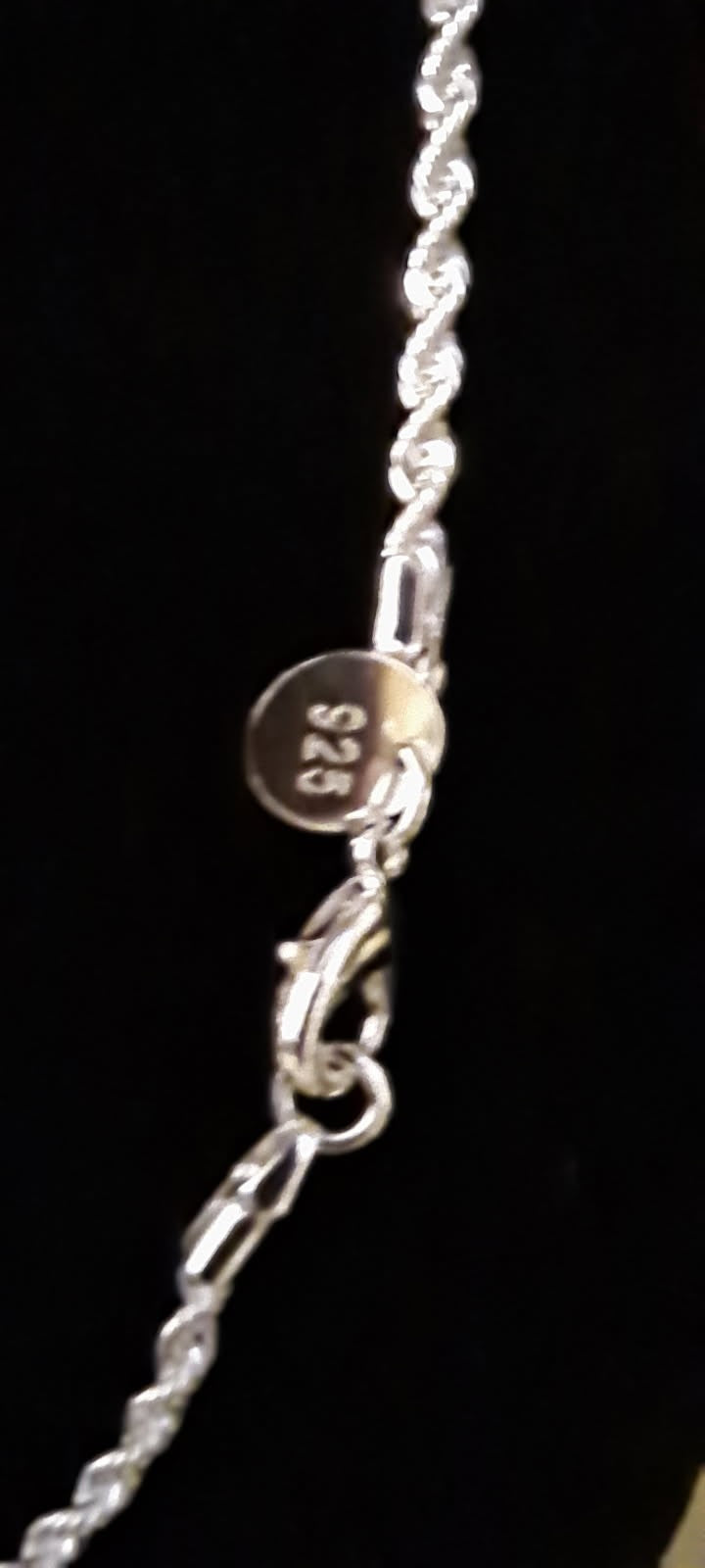 Sterling silver rope chain necklace is 16 inches long. It is made of 925 silver and has a twisted rope design.